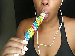 cute ebony chick sucking lollipop