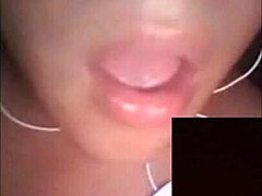 A beautiful woman broadcasts herself live on webcam, interacting with her audience in a sexy way.