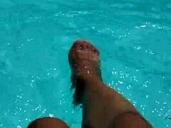 feet splashing playfully in pool with lots of water