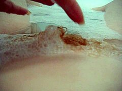 Annie Body Enjoys a Bath with Massive Bubbles While Fingering Her Petite Pussy Close-Up