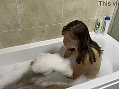 A brunette milf with blue eyes sings in the hairy bathroom
