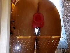 is that girl playing with her pink toy in the shower?