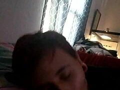 Couple enjoys intimate moment with friend watching