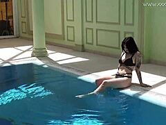 Sheril Blossom, hot Russian teen, strips underwater at beach pool. She shows shaved body in amateur public swim.