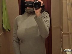 A busty amateur is relaxing by rubbing her wet hair.