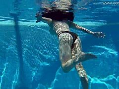 Sheril Blossom, hot Russian teen, strips underwater at beach pool. She shows shaved body in amateur public swim.