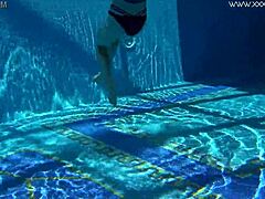 Sheril Blossom, hot Russian teen, strips underwater at beach pool. She shows shaved body in amateur public swim.