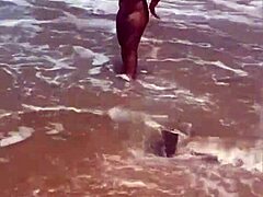 Young African girl flashes naked on beach